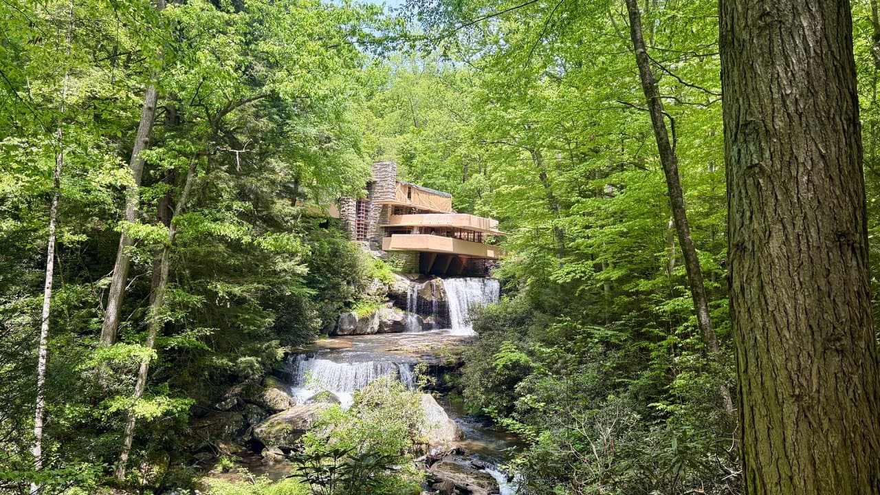 Fallingwater by Frank Lloyd Wright, its cantilevered concrete terraces projecting over a waterfall in the Pennsylvania woods