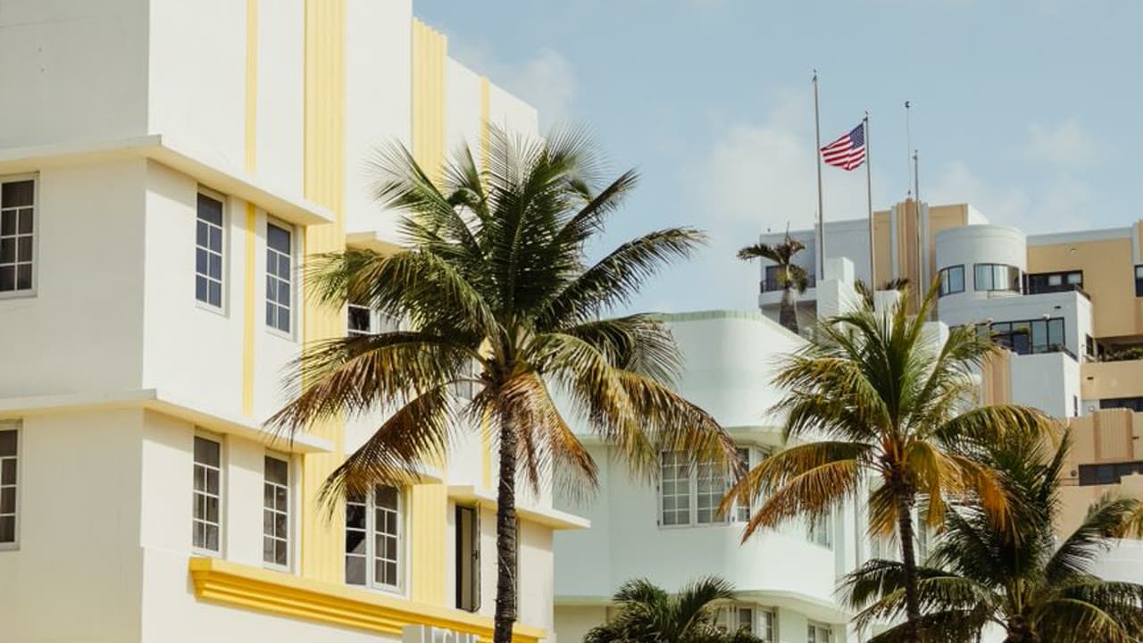 Art Deco buildings with palm trees along Ocean Drive in Miami Beach on a sunny day