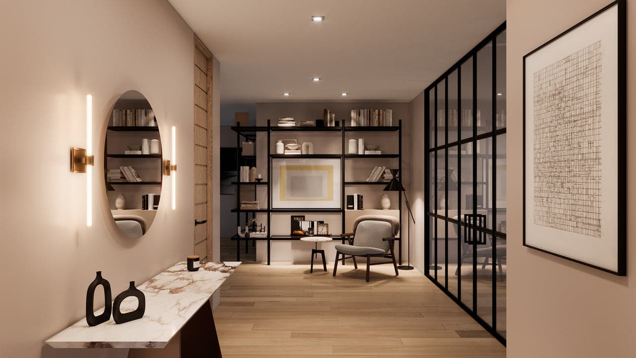 A home study with built-in wood shelving holding books, a desk and a mirror, lit by a single wall sconce