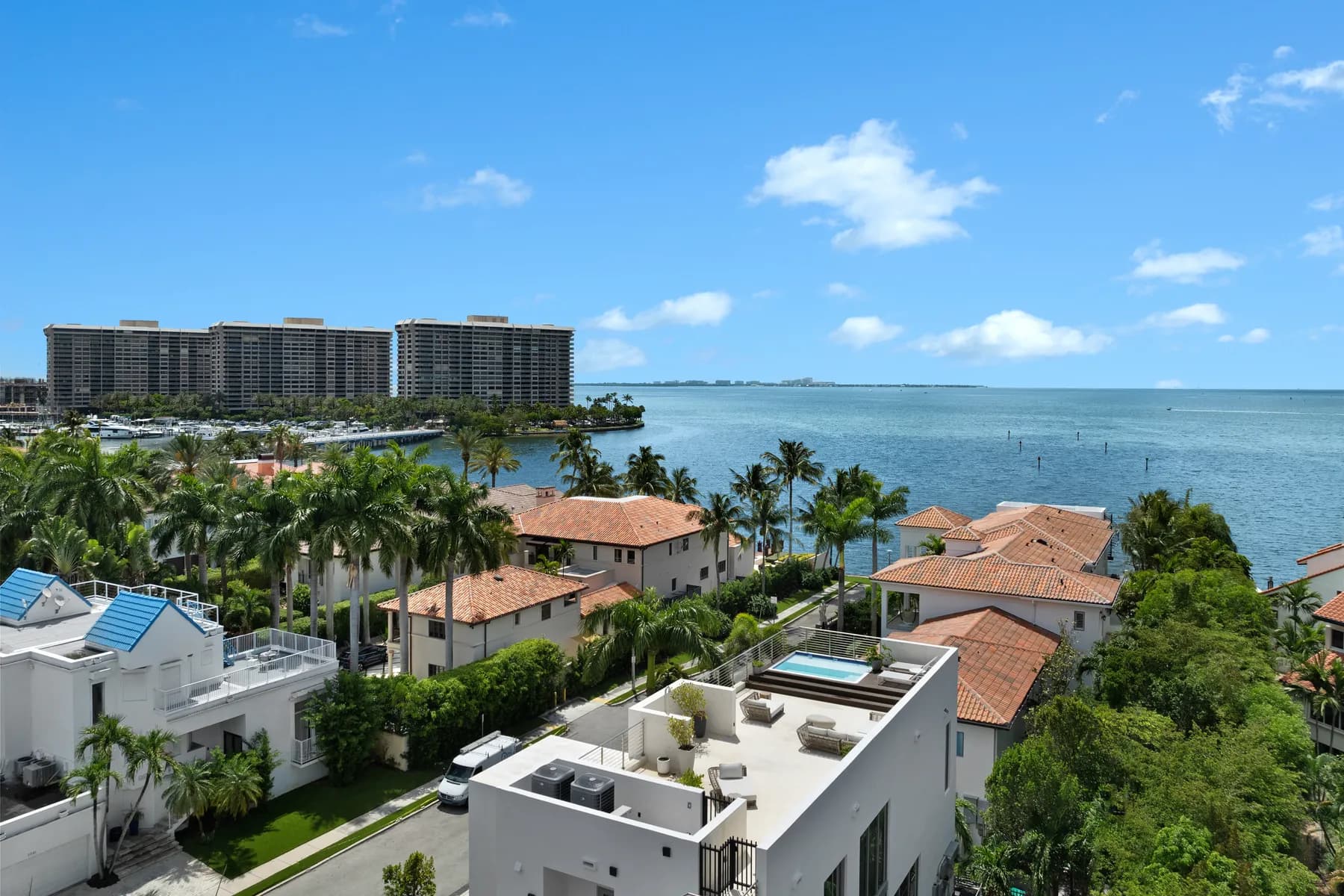 Aerial view of Coconut Grove waterfront homes, tree canopy and Biscayne Bay, showing how each parcel's land sits beside the next